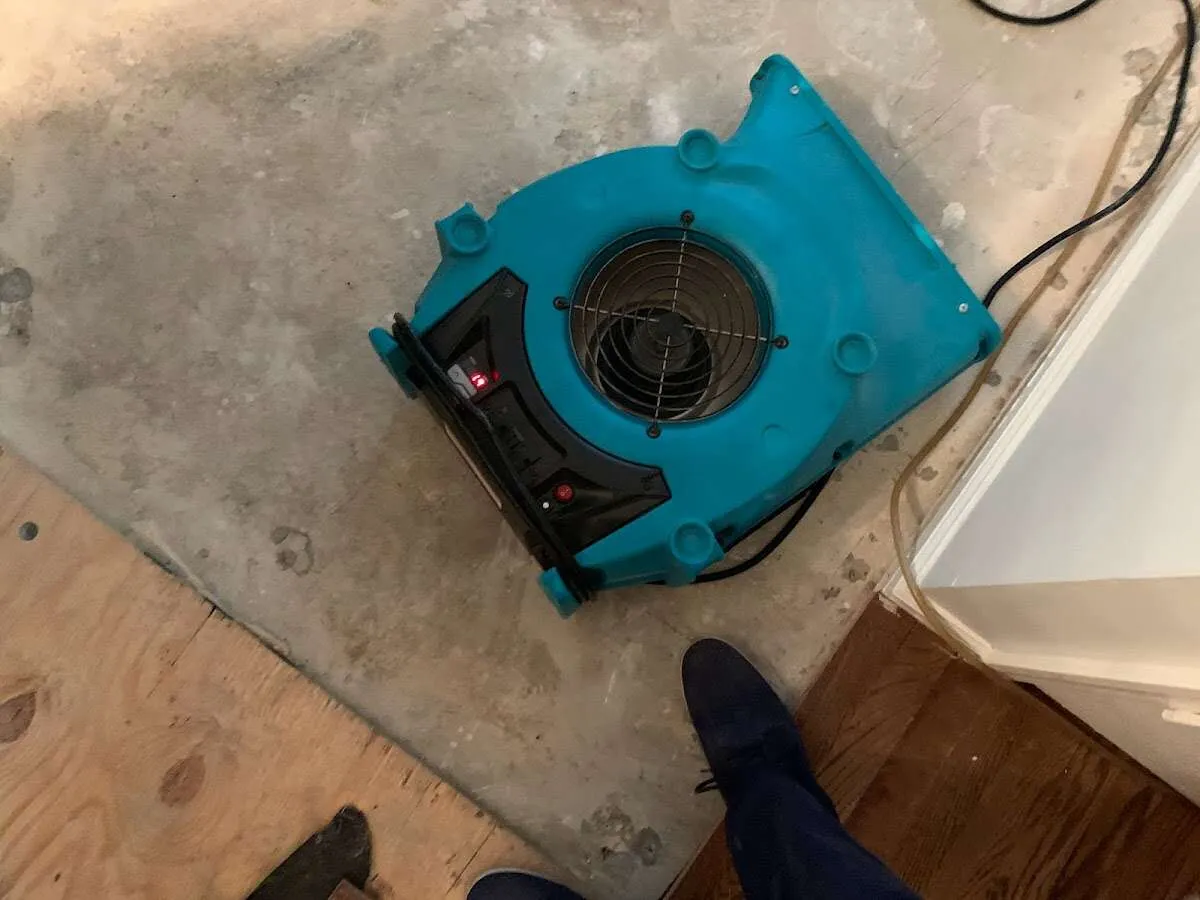 Air mover drying subfloor during Commercial Water Damage Restoration in Bridgton